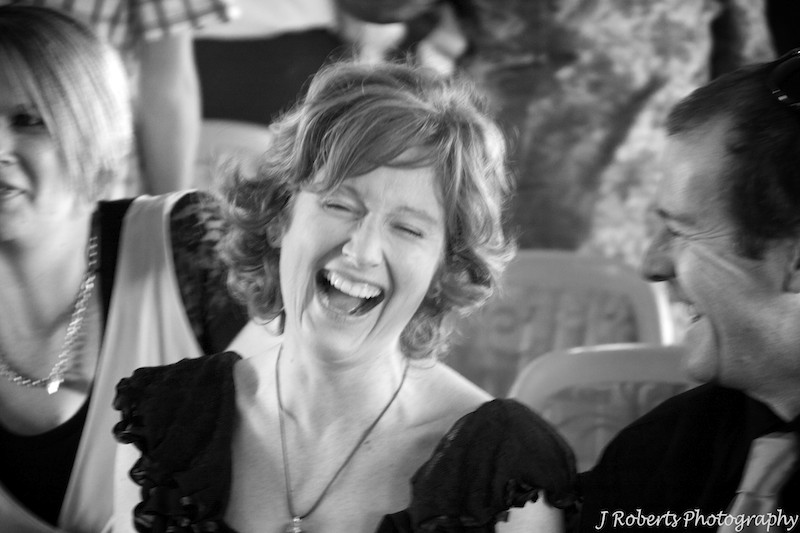 Guest laughing at wedding reception - wedding photography
